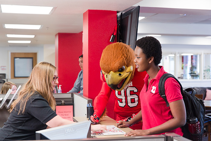 Student and Swoop being helped at the HRE central office