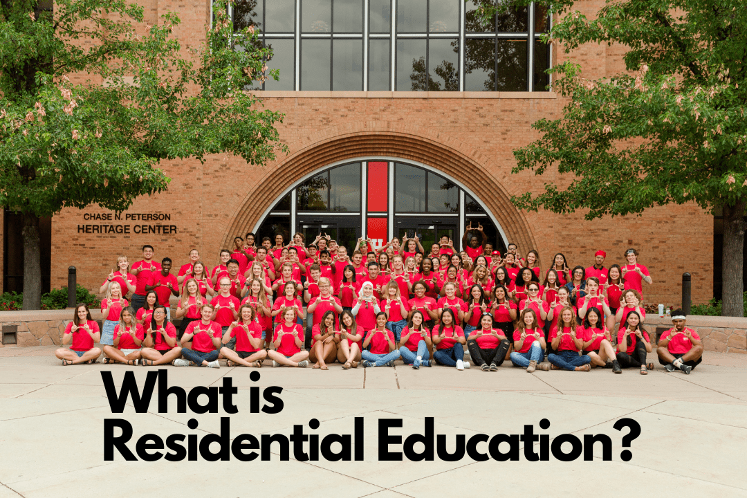 A large group of student leaders posed in front of the PHC with black text centered at the bottom reading What is Residential Education?